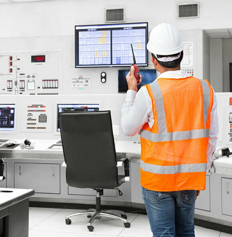 Man looking at screen in nuclear power control center
