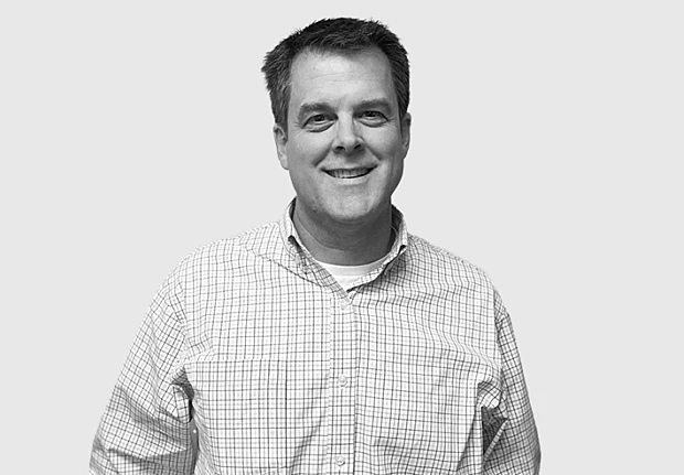 A headshot image of John Ireland