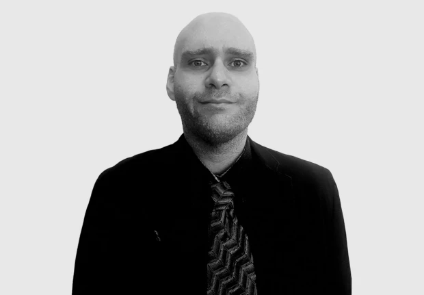 A headshot image of Amir Baroughi