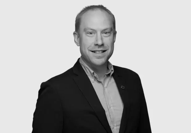 A headshot image of Andrew Wolfe