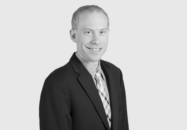 A headshot image of Andrew Wolfe