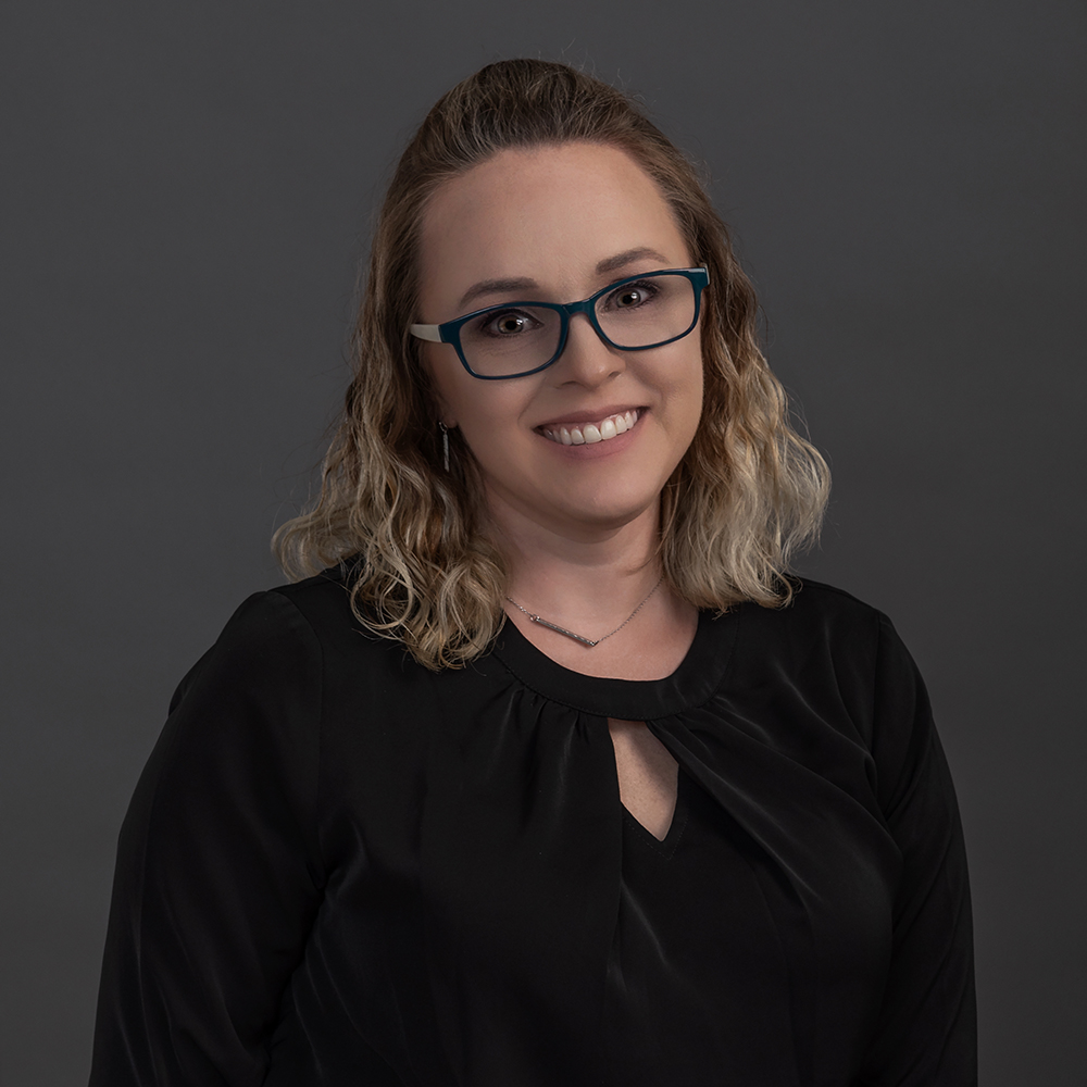 Corporate headshot of a woman wearing glasses