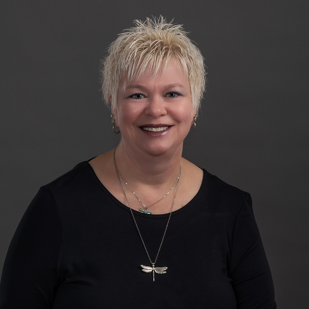 Professional headshot of a silver-haired woman