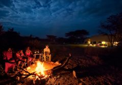 Porini bush camp sitting around the firepit with the locals 1280