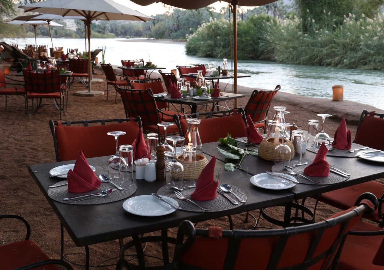 Epupa camp outdoor dining on the river 1280
