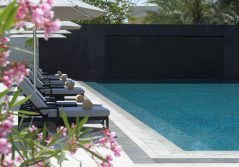 Kempinski hotel muscat sun loungers by the pool 1280