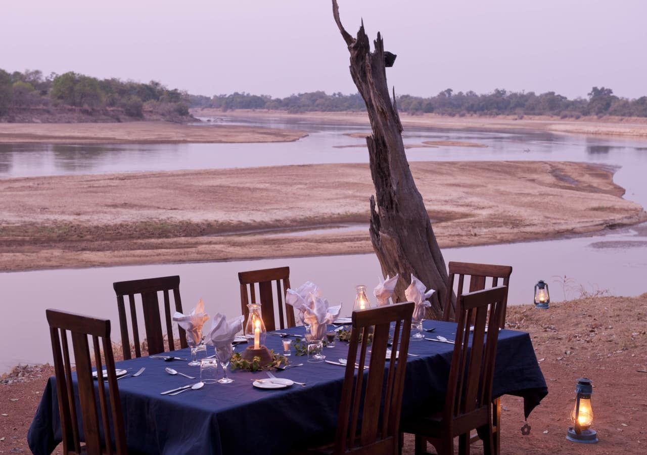 Nsefu camp dining on the riverbank 1280
