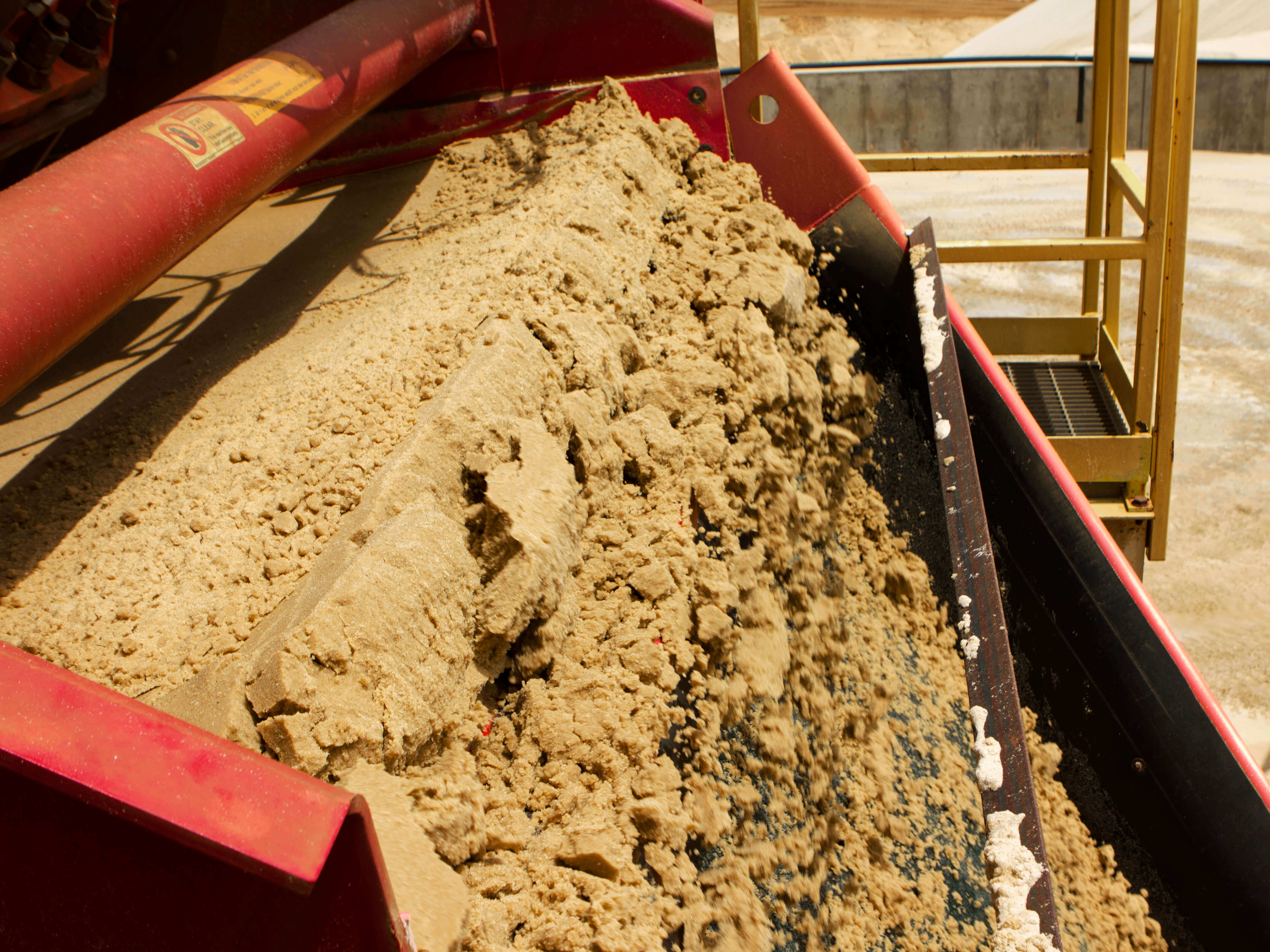 Side view of a Dewatering Screen discharge chute with sand.