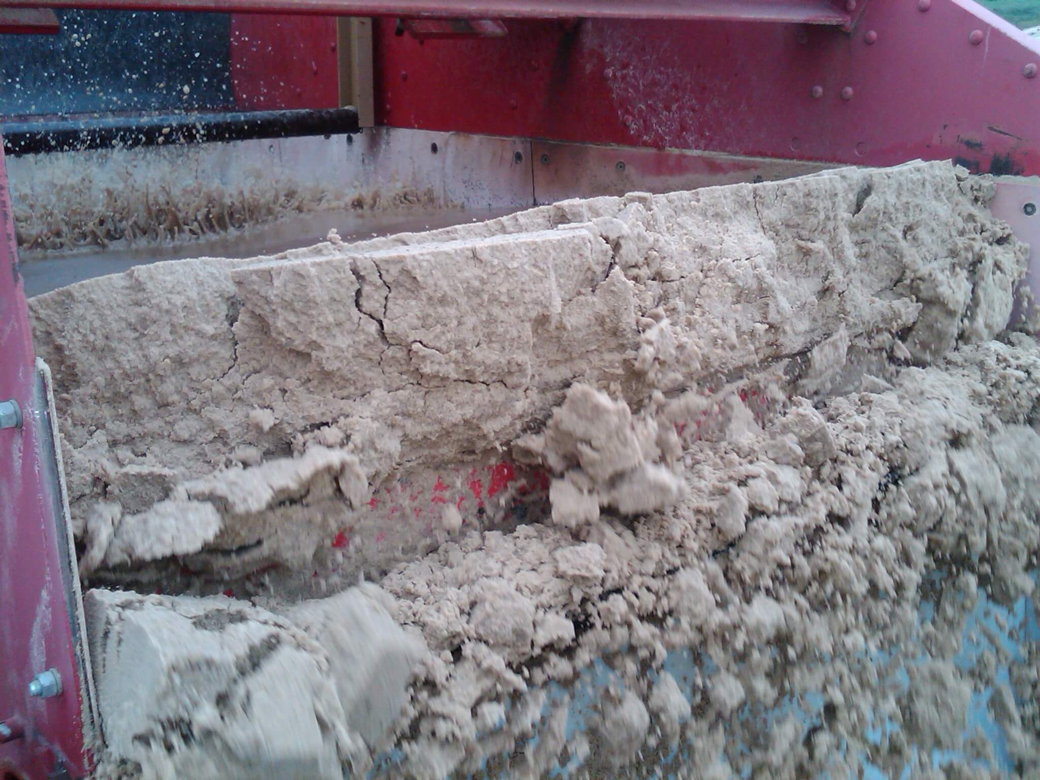 Close-up of sand coming off of a Dewatering Screen.