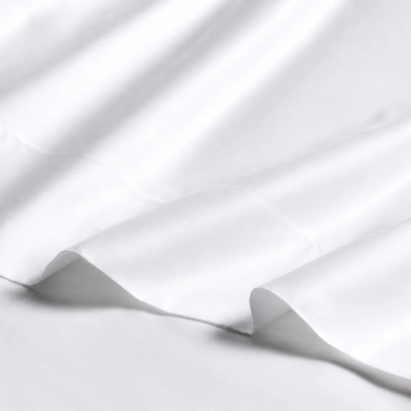 sateen sheet set in white — stitching and closure detail