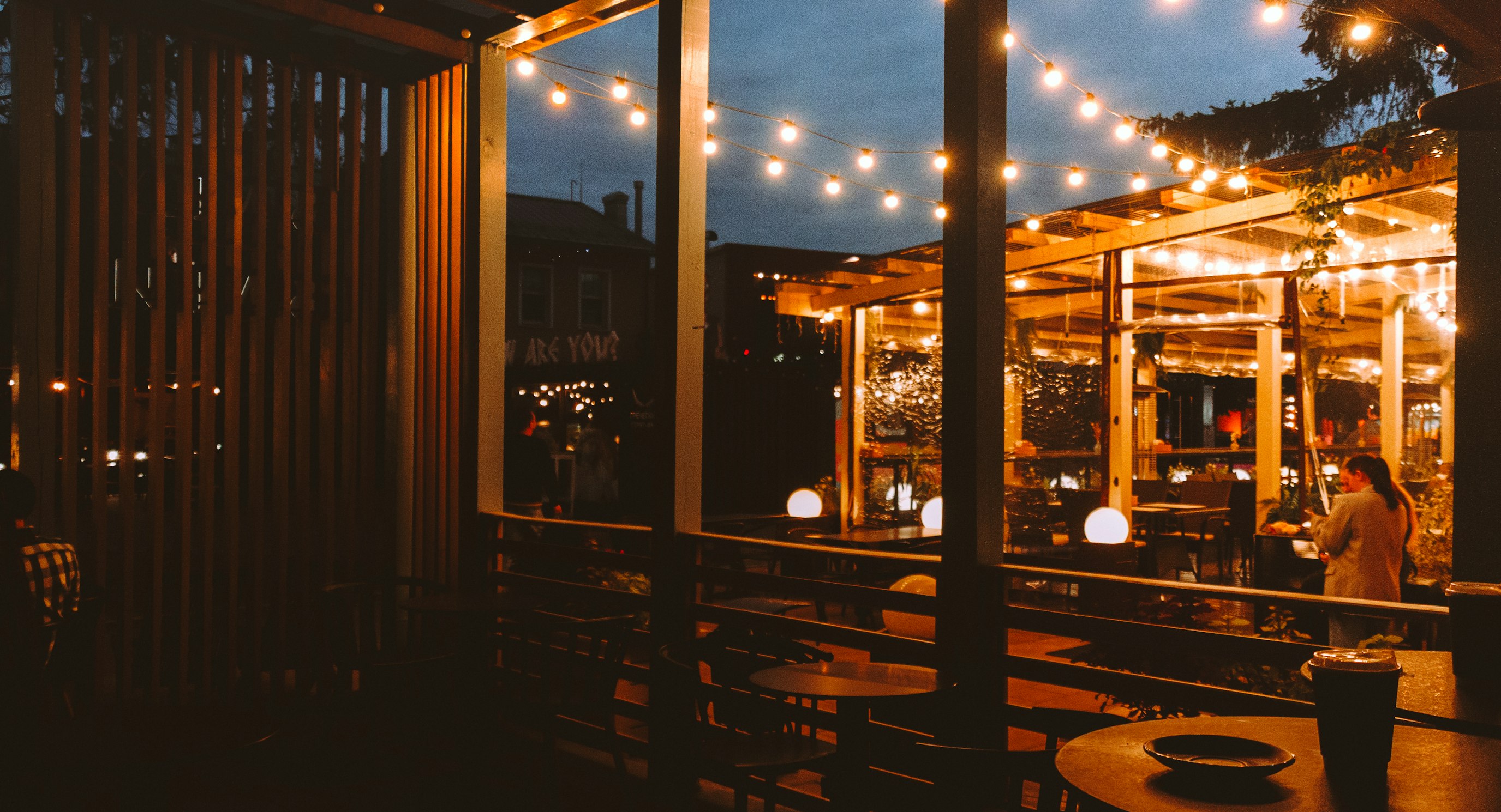 Outdoor patio strung with warm string lights at dusk