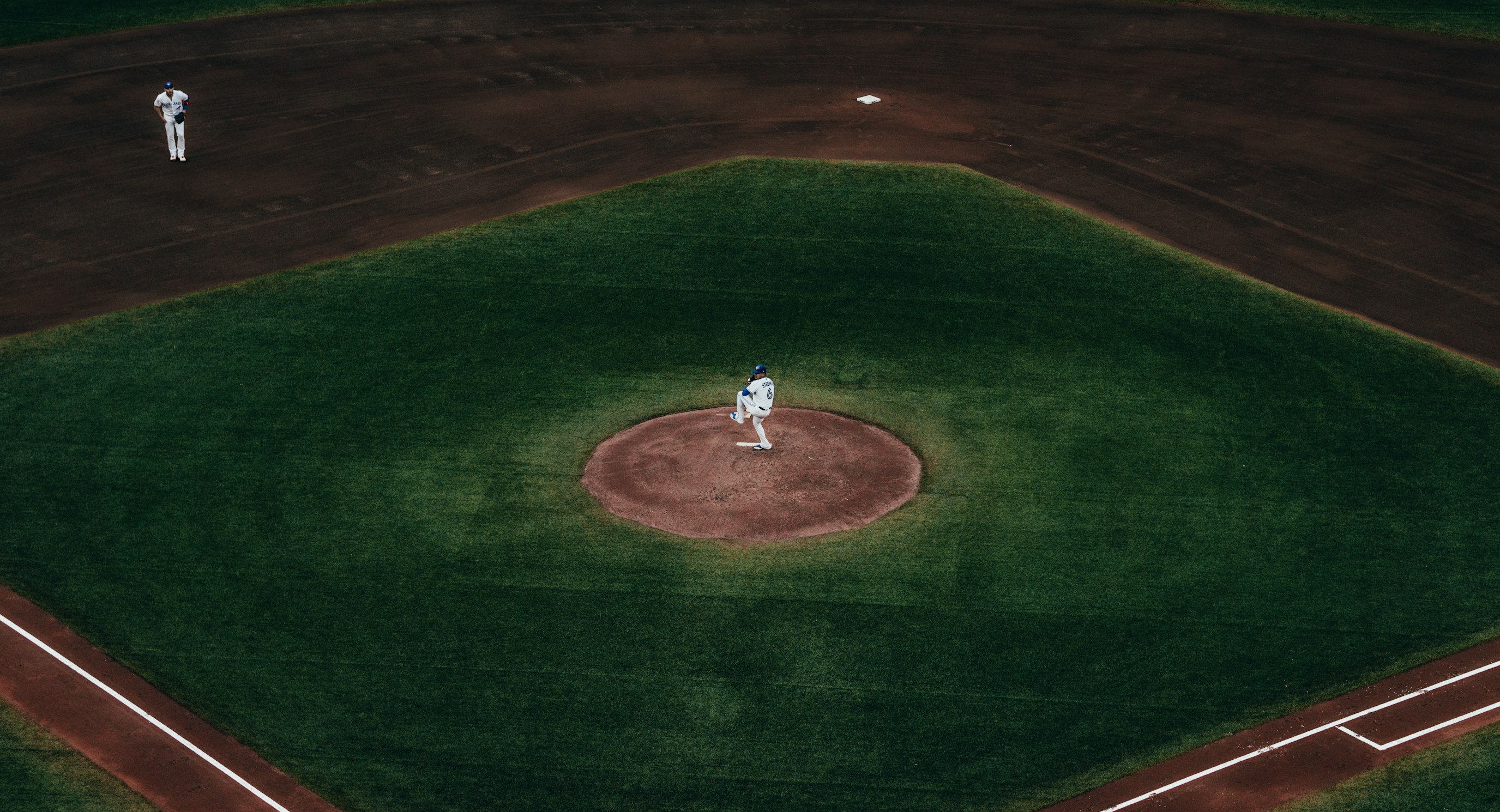 Pitcher on the mound at a baseball field