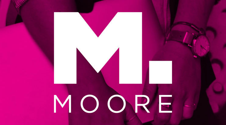 Moore logo with hands holding a computer in the background