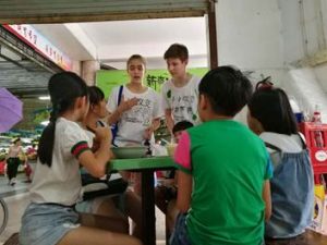 NSLI-Y Chinese participants discuss plastic waste with local children.