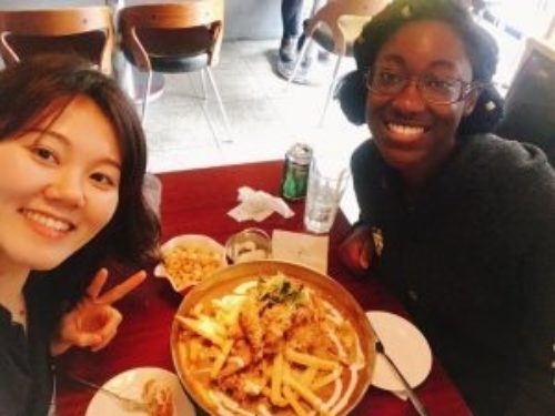 image of alex taking a photo with a friend