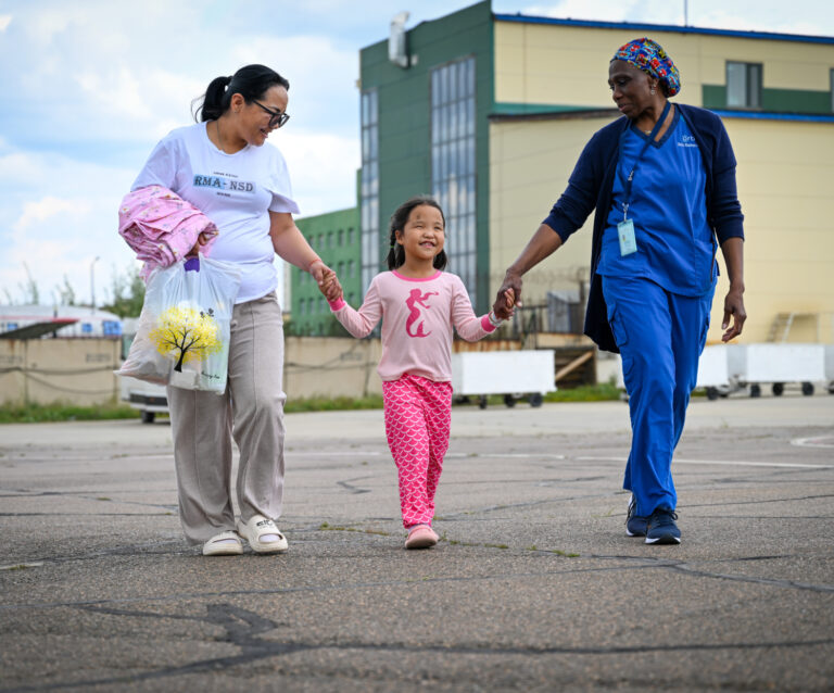 Buyandeleger walking to plane - FEH Mongolia Patient 2024