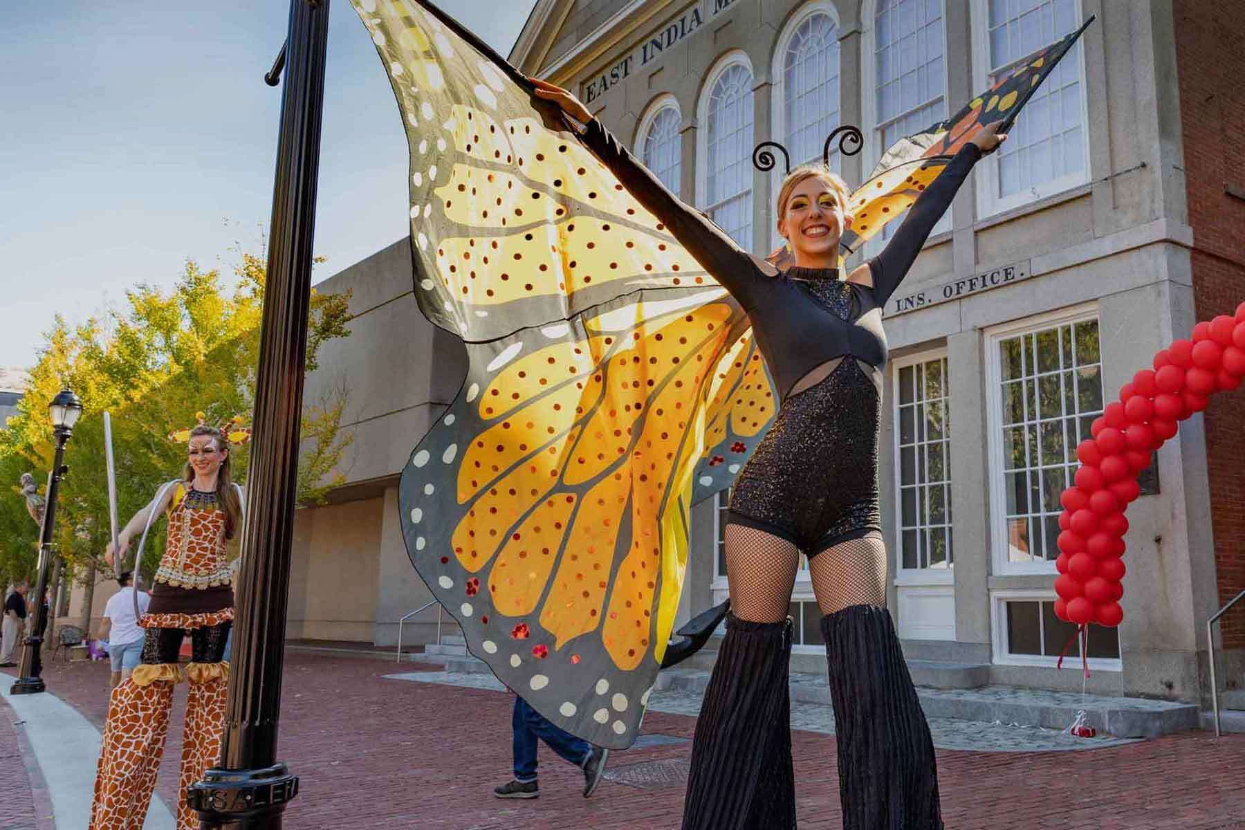 Image of a woman on stilts dressed as a butterfly