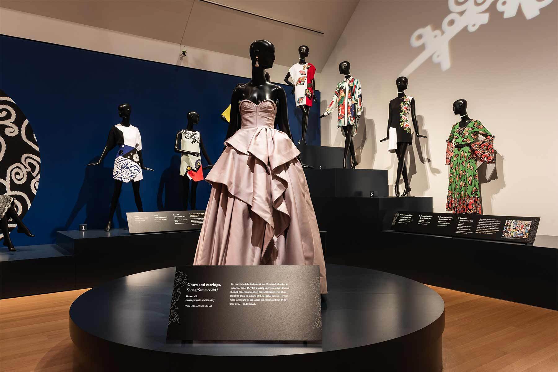 Mannequins in Andrew Gn ensembles pose on risers in PEM’s gallery.