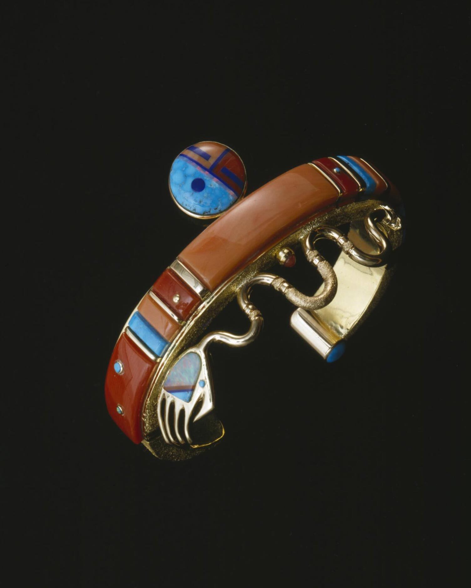 Jesse Monongya, Hopi Pueblo and Diné (Navajo), born 1952. Spiritual Hand, 2002. Gold, opal, coral, and turquoise. Museum purchase, made possible by Catherine B. Wygant and Sally Loring, 2002. E301995. © Jesse Monongya. Image courtesy of the Peabody Essex