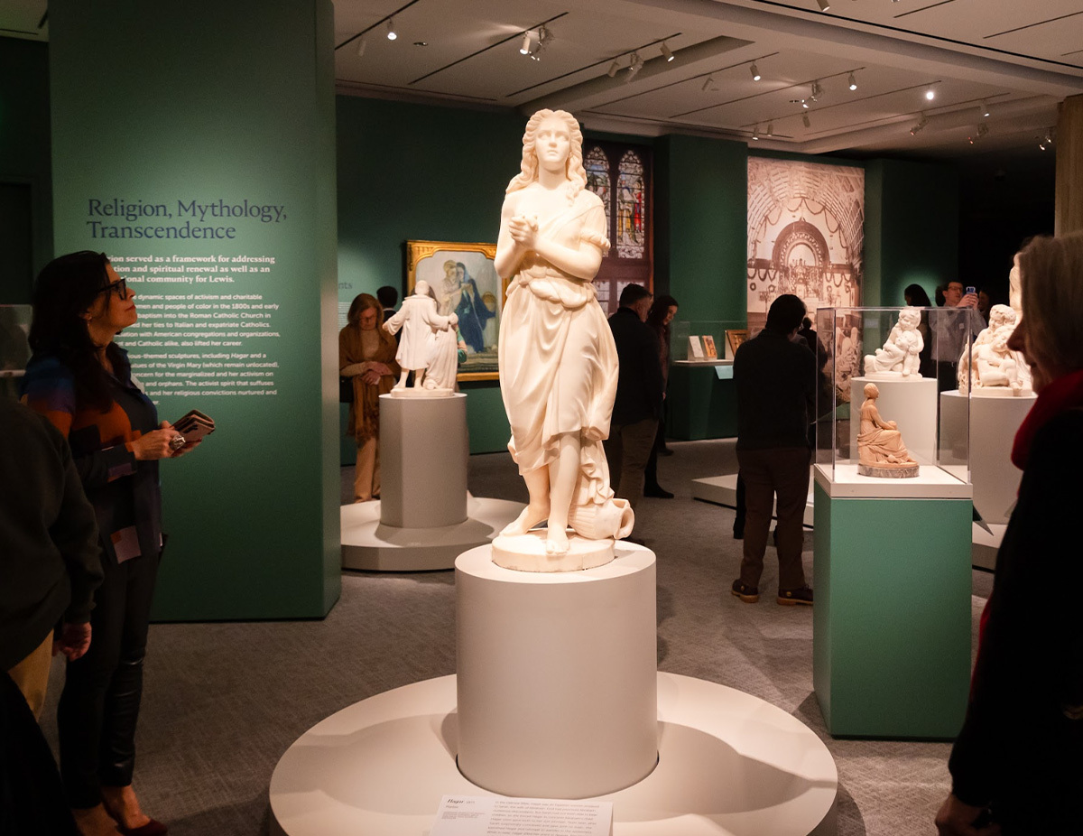 Museum visitors admire Edmonia Lewis’ works in the gallery at PEM.