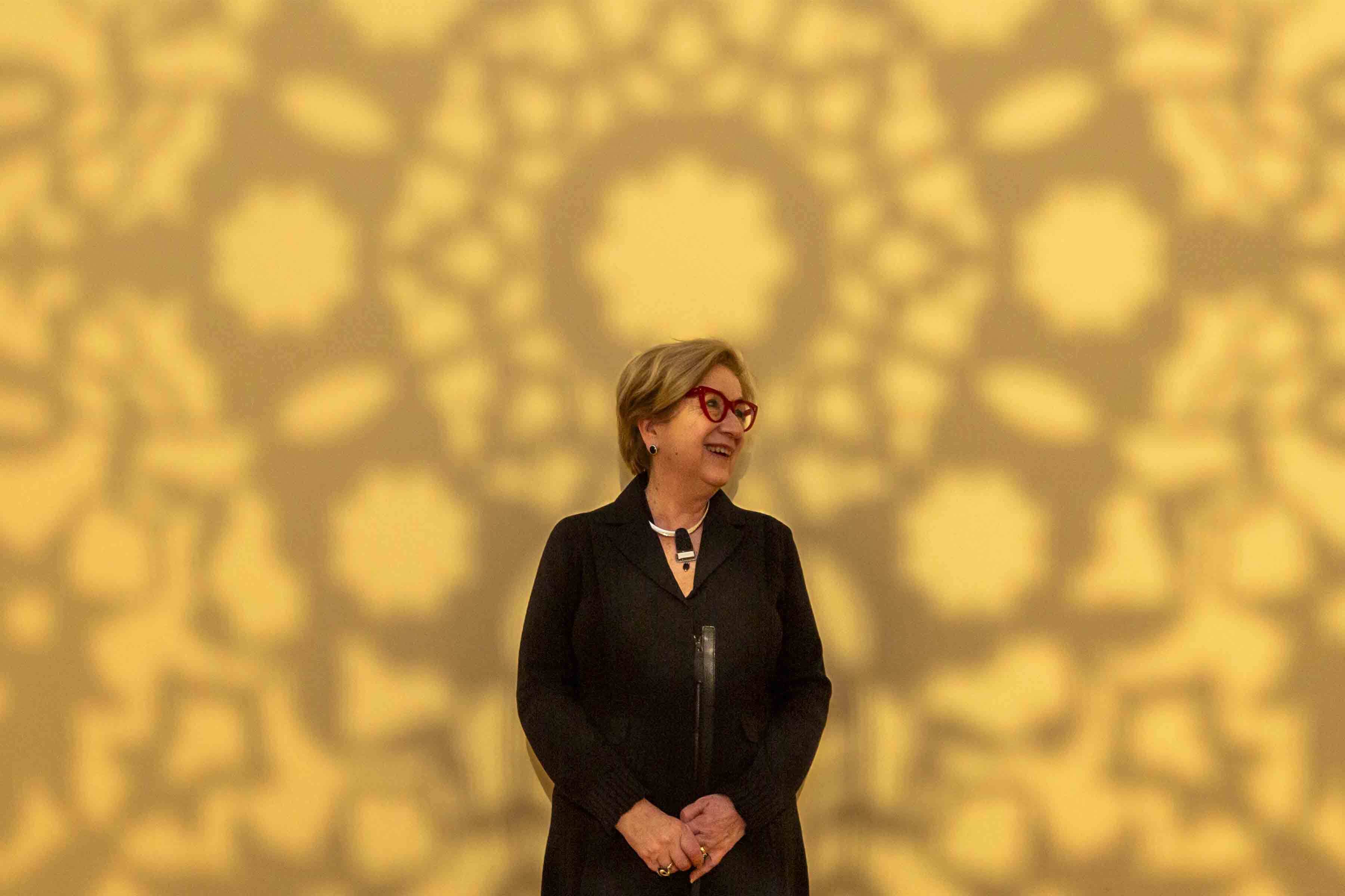Lynda Roscoe Hartigan enjoying a moment in the Anila Quayyum Agha’s All the Flowers Are For Me. Photo by Kathy Tarantola/PEM.