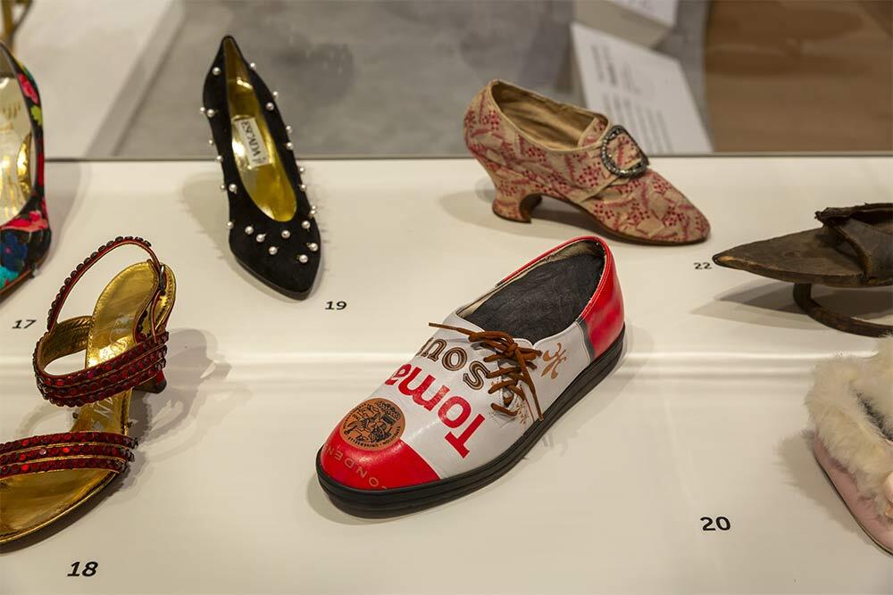 A gift to the museum left behind by Lynda Hartigan, a pair of tomato soup can shoes made in 1999 that reflect the iconic work by Andy Warhol. Photo by Kathy Tarantola/PEM.