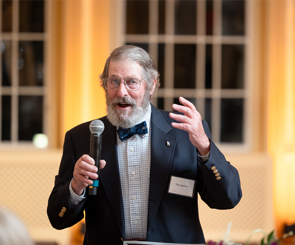 Tim Ingraham speaking at the East India Marine Hall dinner in 2024