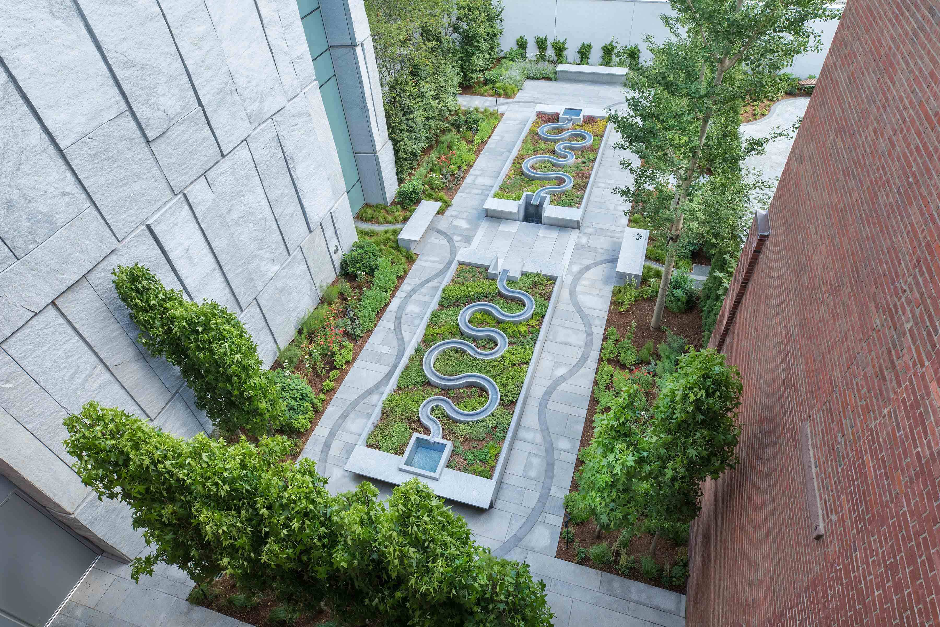 Outdoor museum garden and fountain featuring plants and cascading water