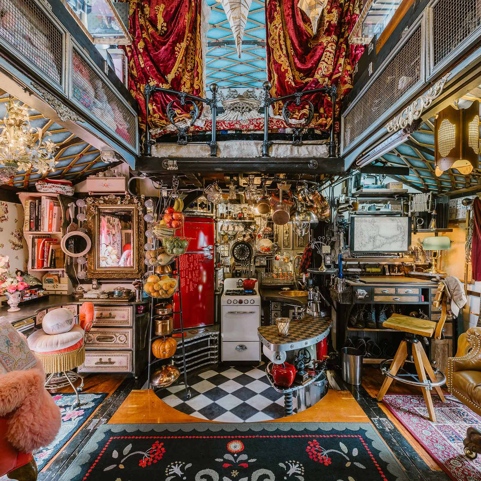 Richly ornate interior of a custom steampunk caravan filled with eclectic decor