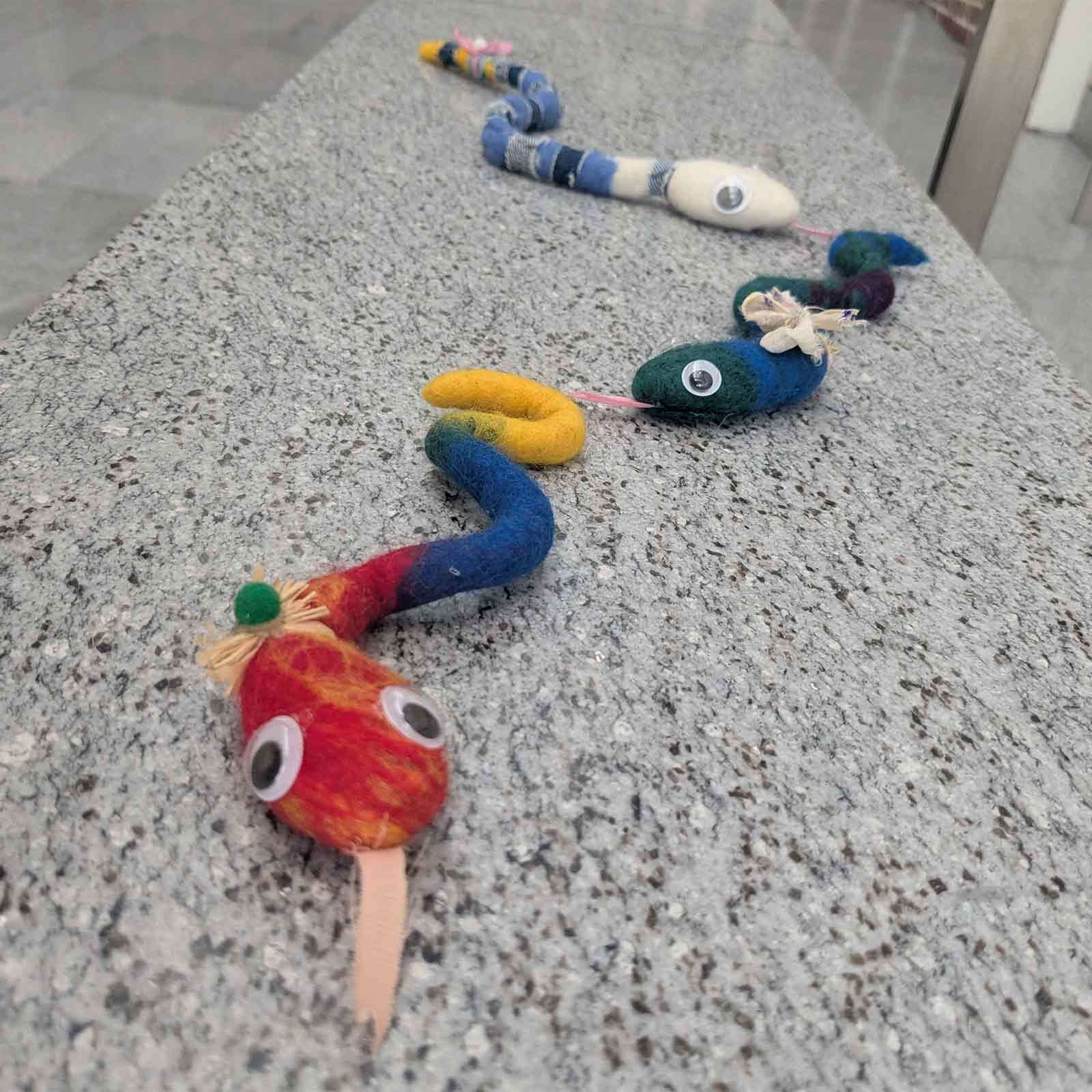 Three wet-felted snakes