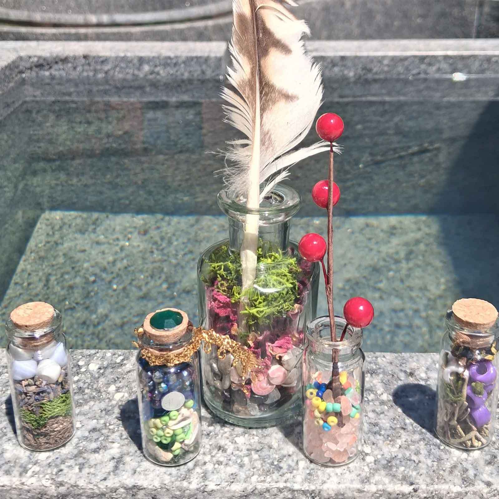 Magic bottles against the Ropes Mansion garden water feature