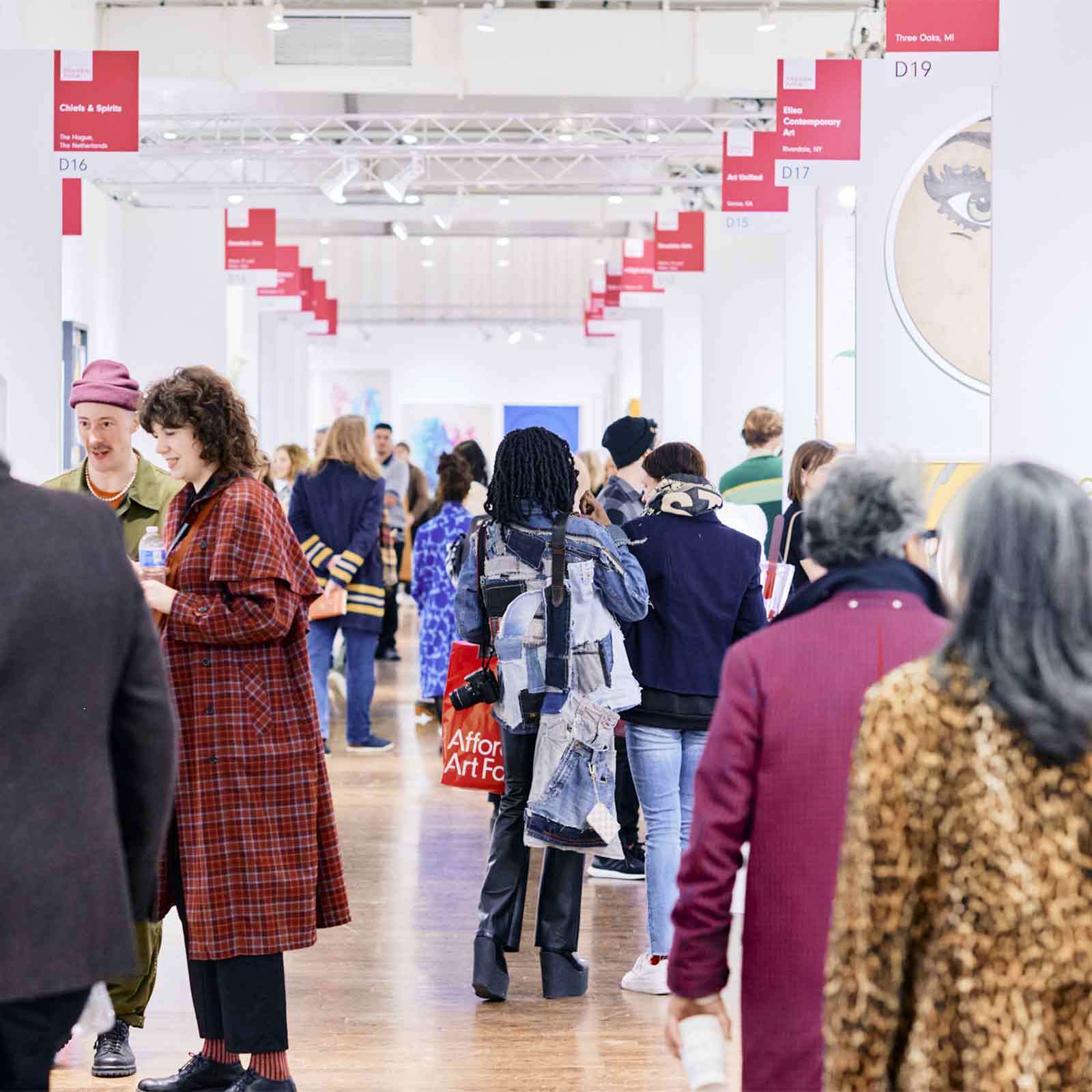 Visitors looking at art at the Affordable Art Fair