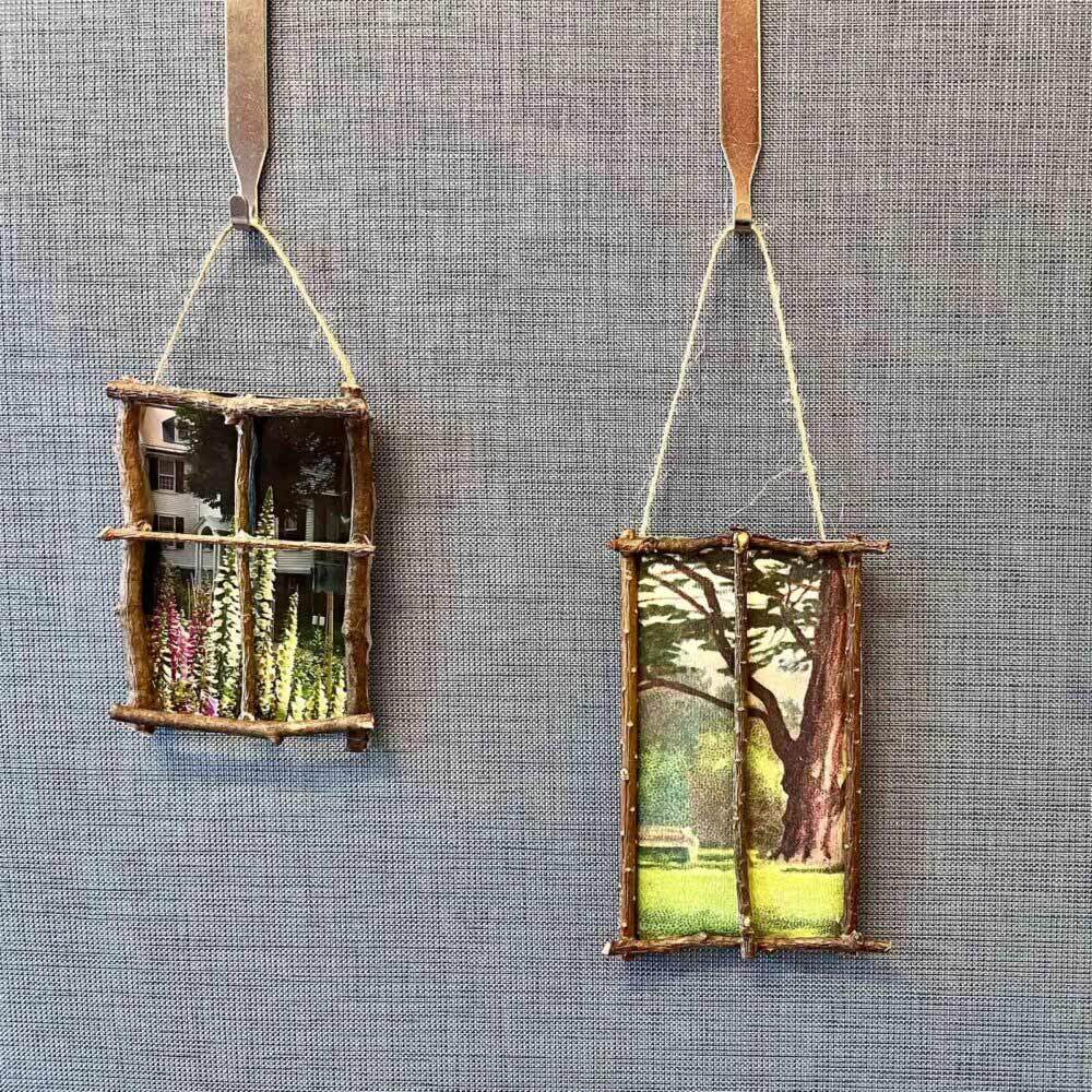 Tiny window frames made of sticks depicting garden imagery