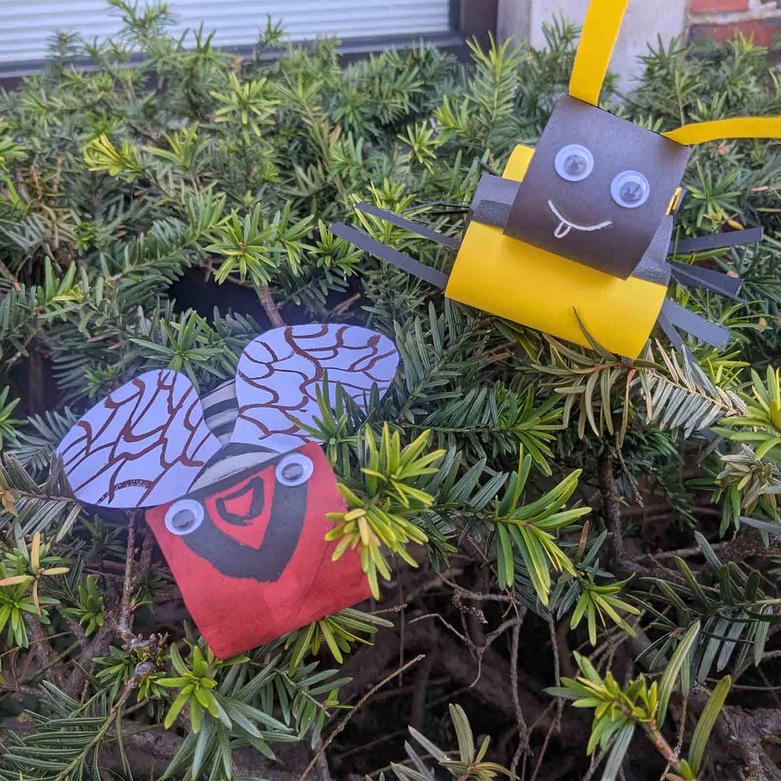 A yellow bee and a red ladybug made out of craft paper and rolls