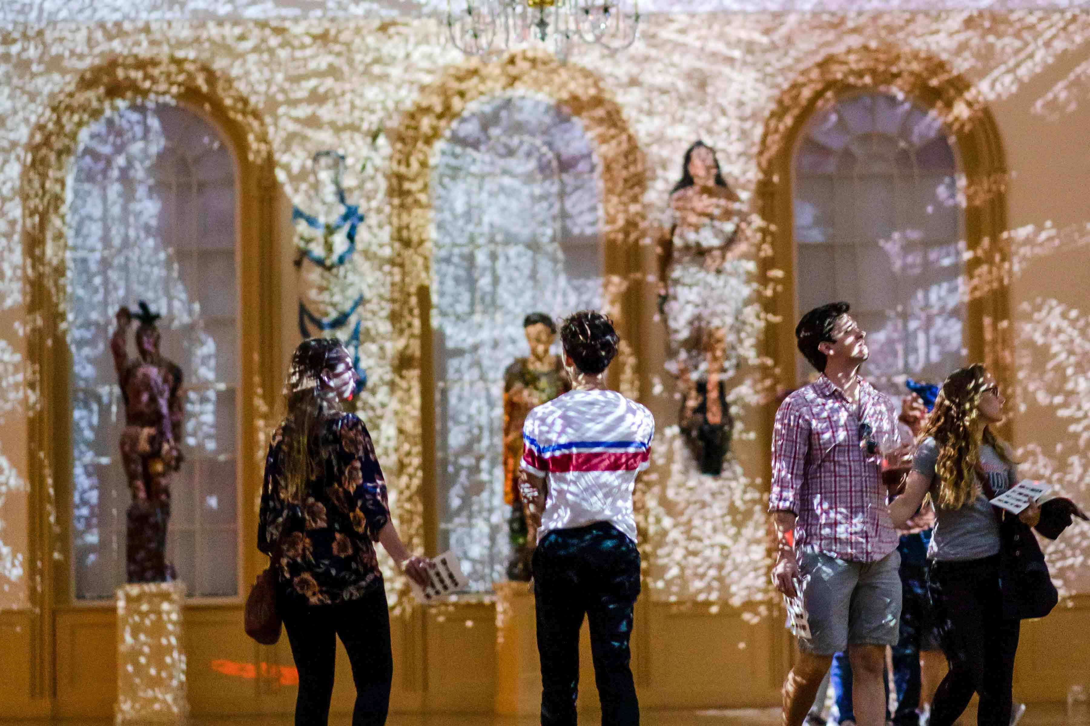 Visitors in East India Marine Hall viewing the Charles Sandison:Figurehead2.0 exhibition.