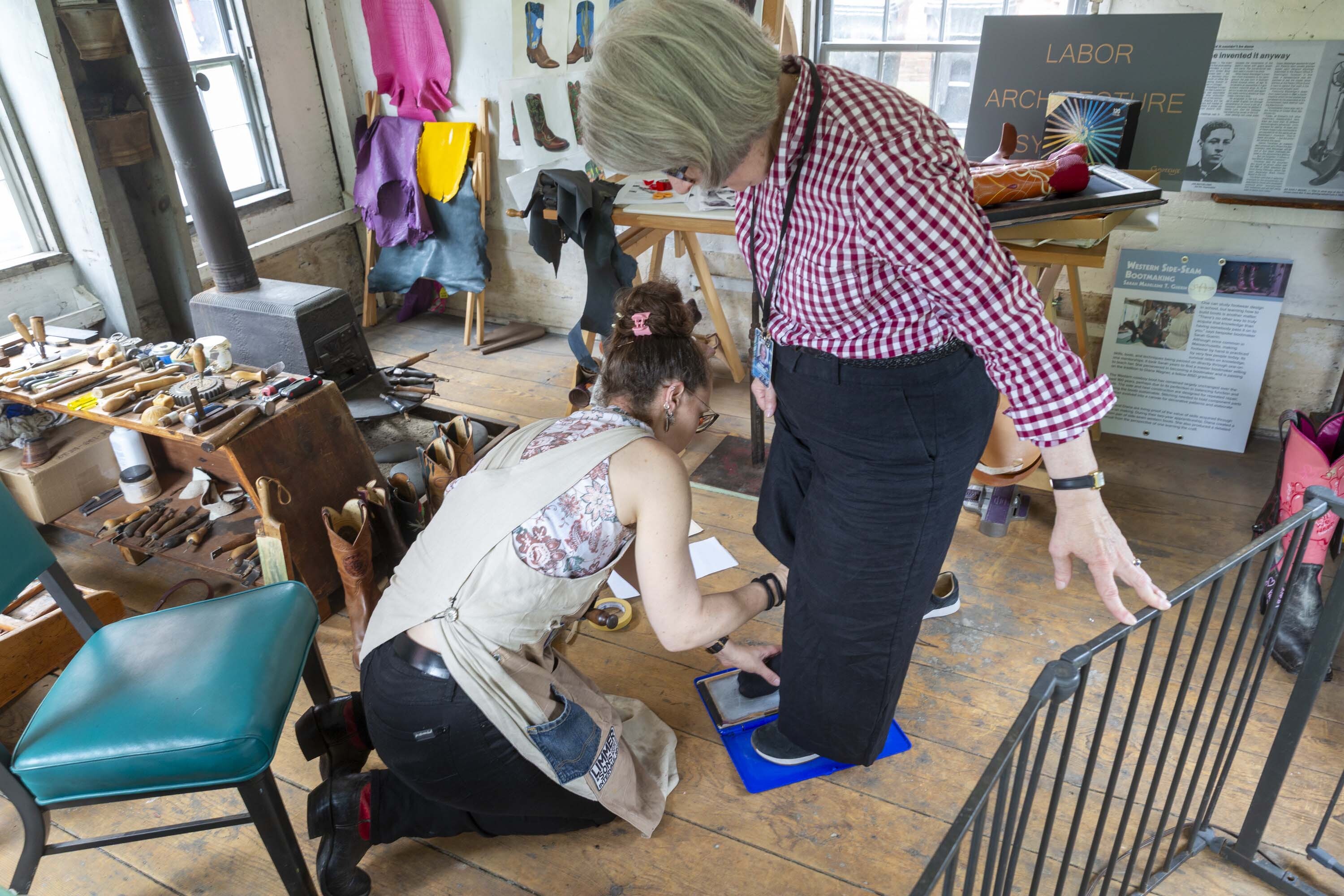 Sarah Guerin measuring Paula Richter’s feet. Photo by Kathy Tarantola/PEM.