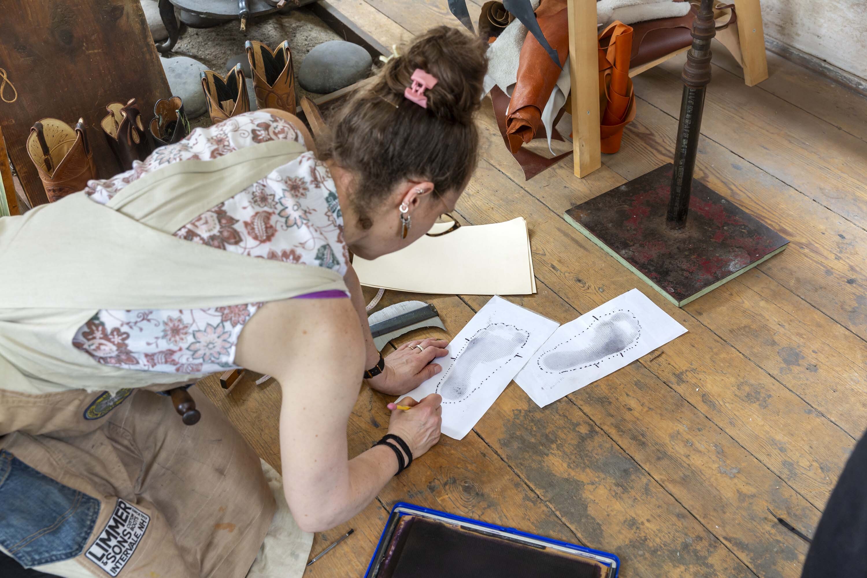Sarah Guerin preparing drawings to make boots to fit Paula Richter. Photo by Kathy Tarantola/PEM.