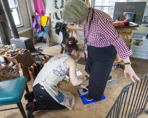 Sarah Guerin measuring Paula Richter’s feet. Photo by Kathy Tarantola/PEM.