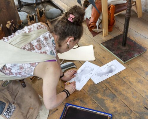 Sarah Guerin preparing drawings to make boots to fit Paula Richter. Photo by Kathy Tarantola/PEM.
