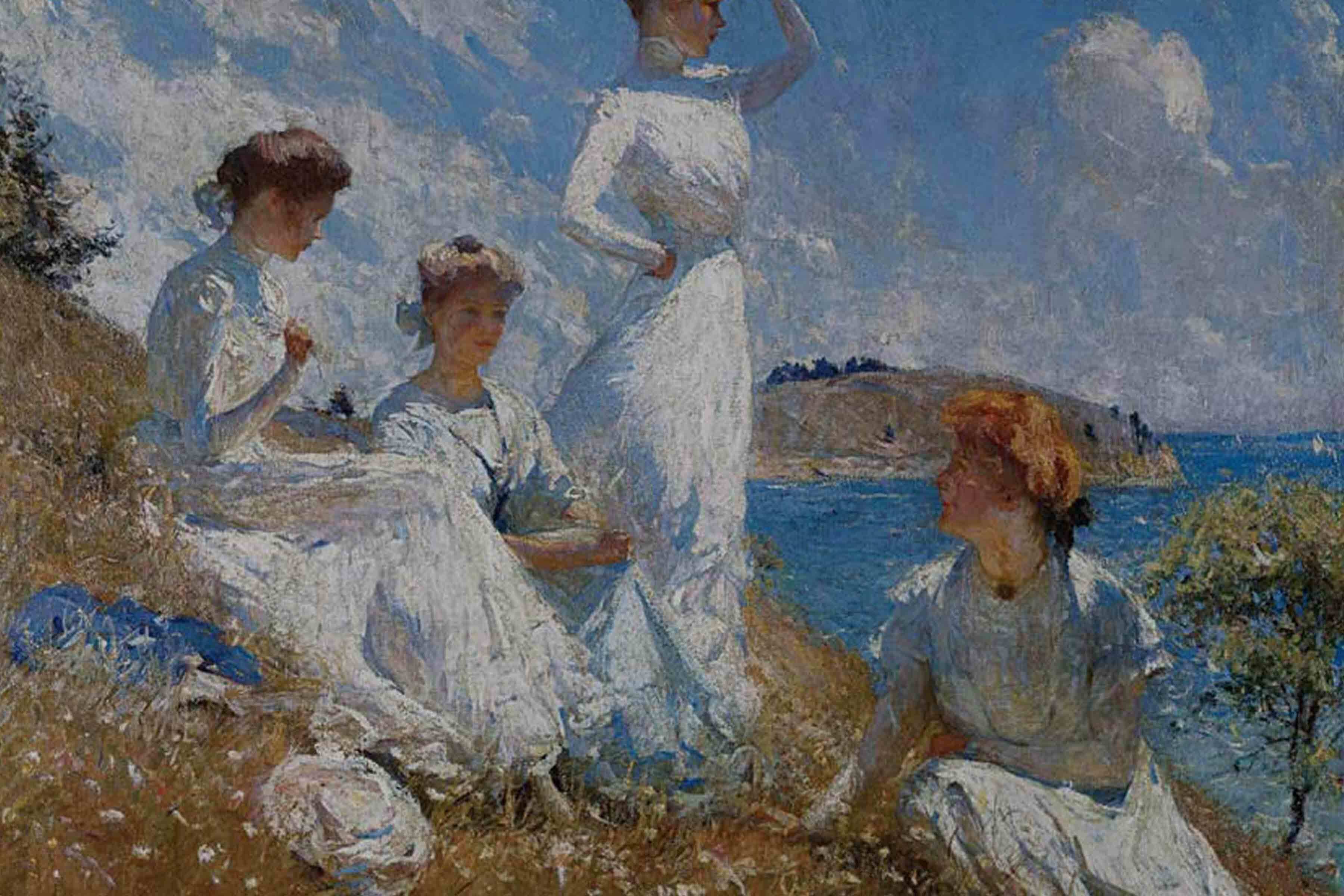 4 women in long white dresses sitting on a field bank overlooking the ocean.