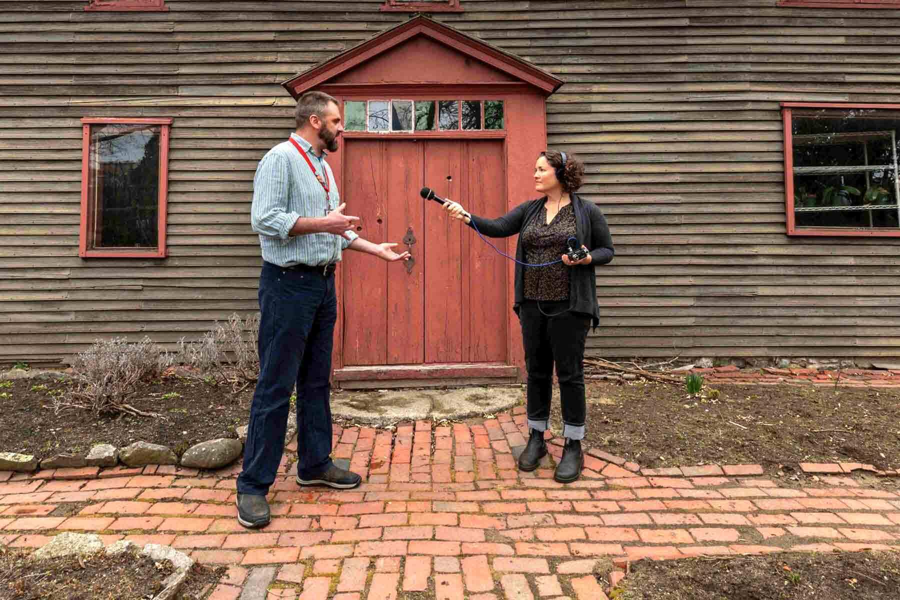 Two people talking in front of the Samuel Pickman House