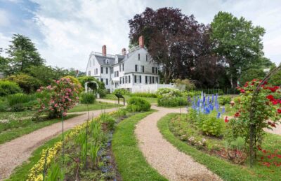 The Ropes Mansion garden in full bloom with the white mansion in the background