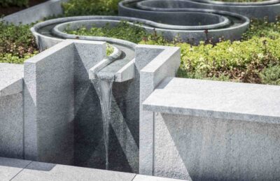 New museum garden detail view of a granite wall and waterfall