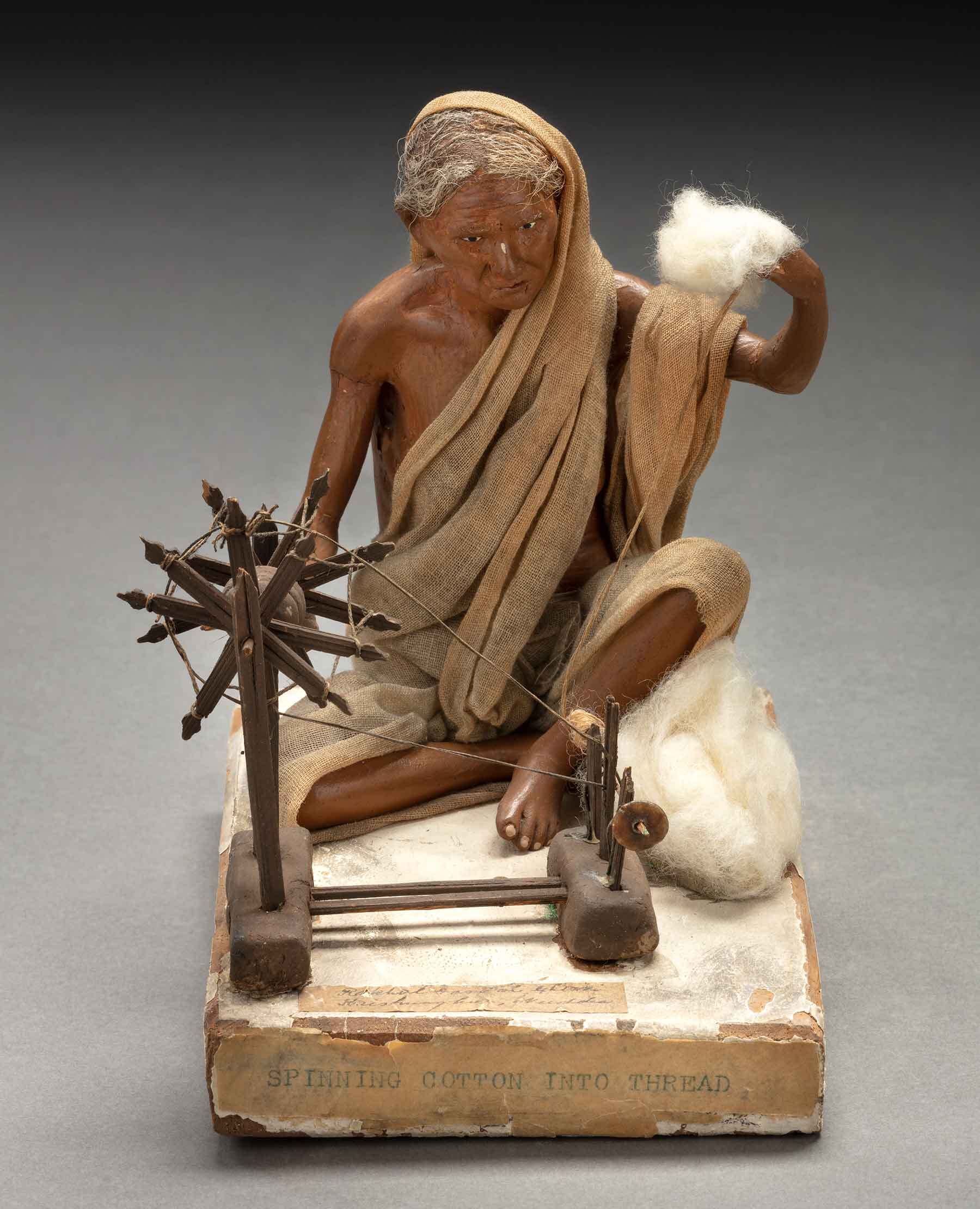 Artists in Kolkata or Krishnanagar. Woman spinning cotton, 19th century. Unfired clay, textile, paint, wood, cotton, and hair. Gift of Henry Peabody & Company, 1968. E44821.