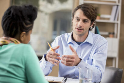 Photo of a man talking to a woman in the office