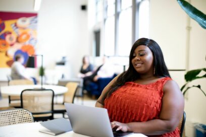Plus size woman taking a DEI survey in bright, open office workplace