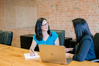 two women in a meeting, in front of a laptop