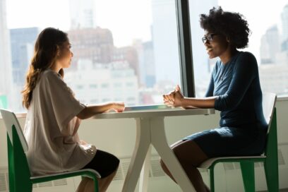 Two women having a conversation at work