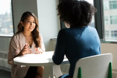 two women at a table having an interview