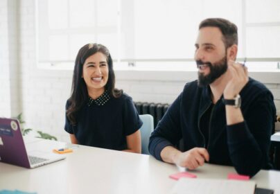 two people in an office smiling